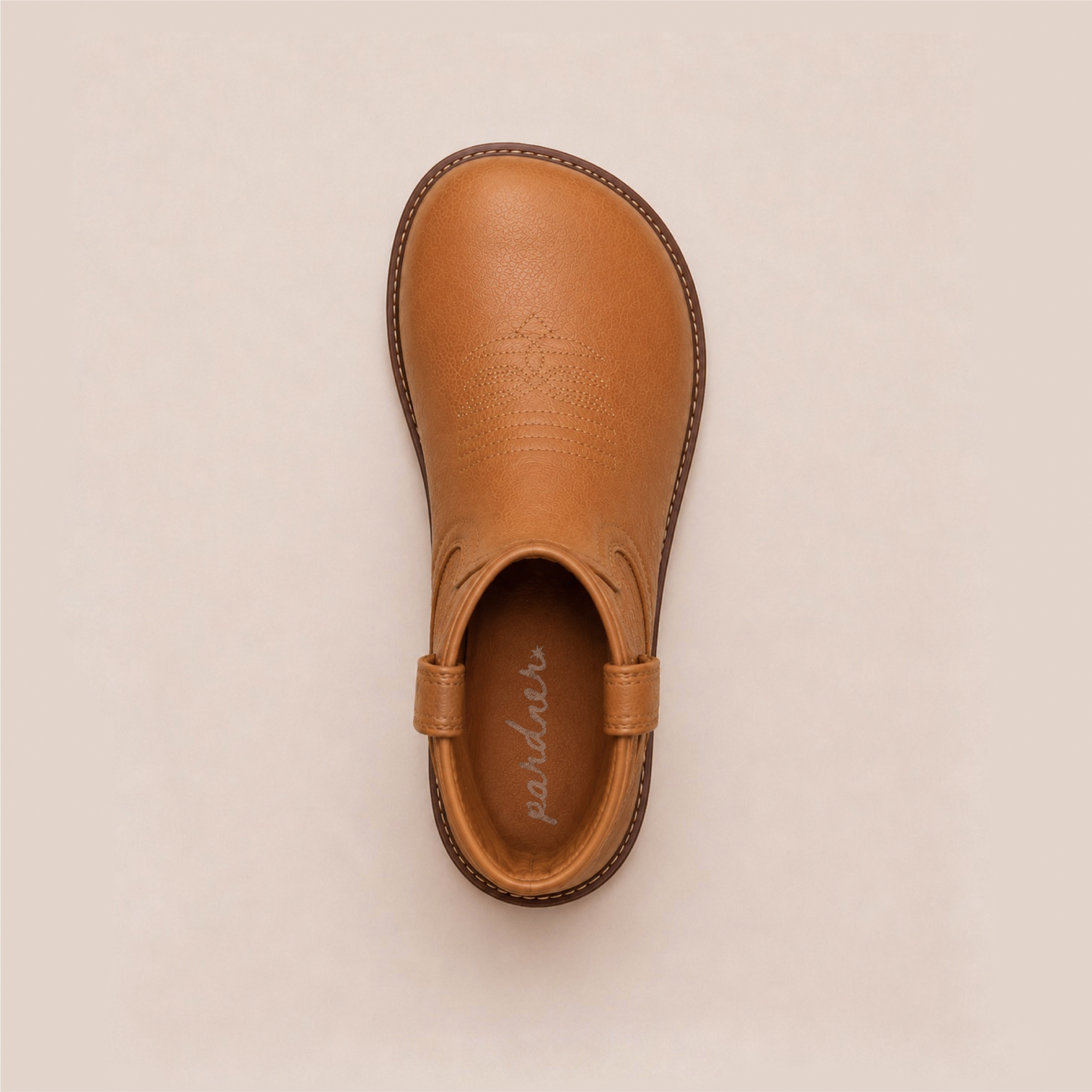 Top-down view of the caramel kids' western boot showing the wide, rounded toe box and the pardner logo on the insole.